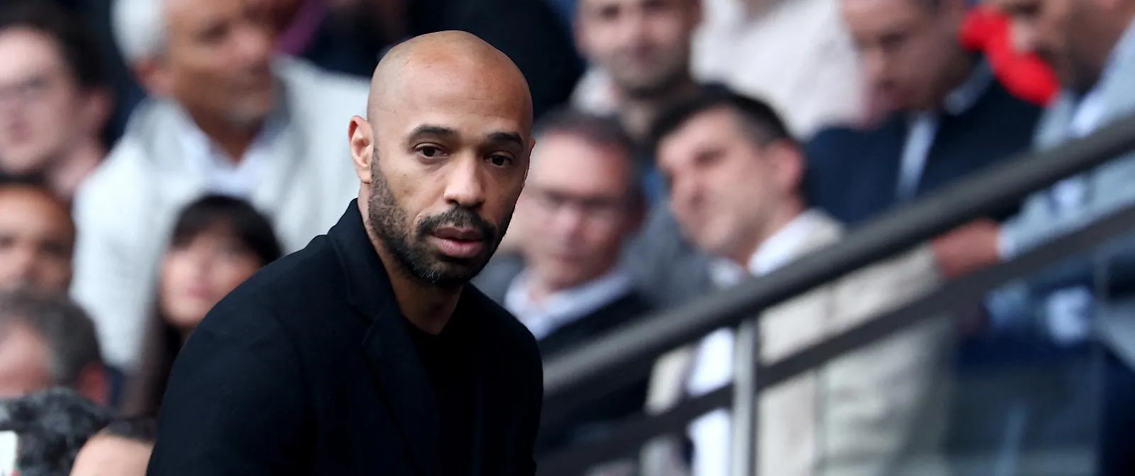 French Olympic football team coach Thierry Henry arrives in the stand before attending the French L1 football match between Paris Saint-Germain (PSG) and Toulouse (TFC) on May 12, 2024 at the Parc des Princes stadium in Paris. (Photo by FRANCK FIFE / AFP)